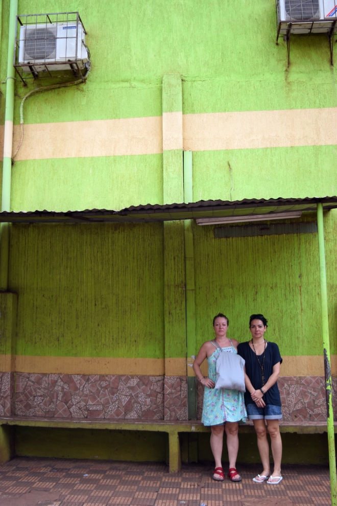 girls in front of green wall in ciudad del este, paraguay