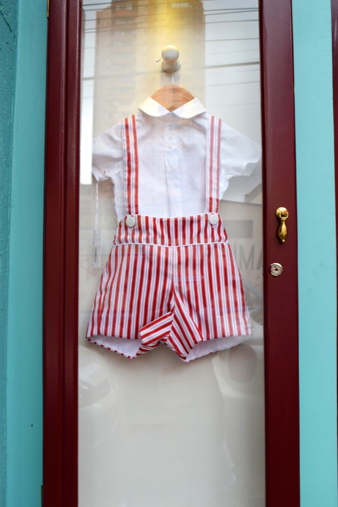 a little boy's outfit for sale framed into glass